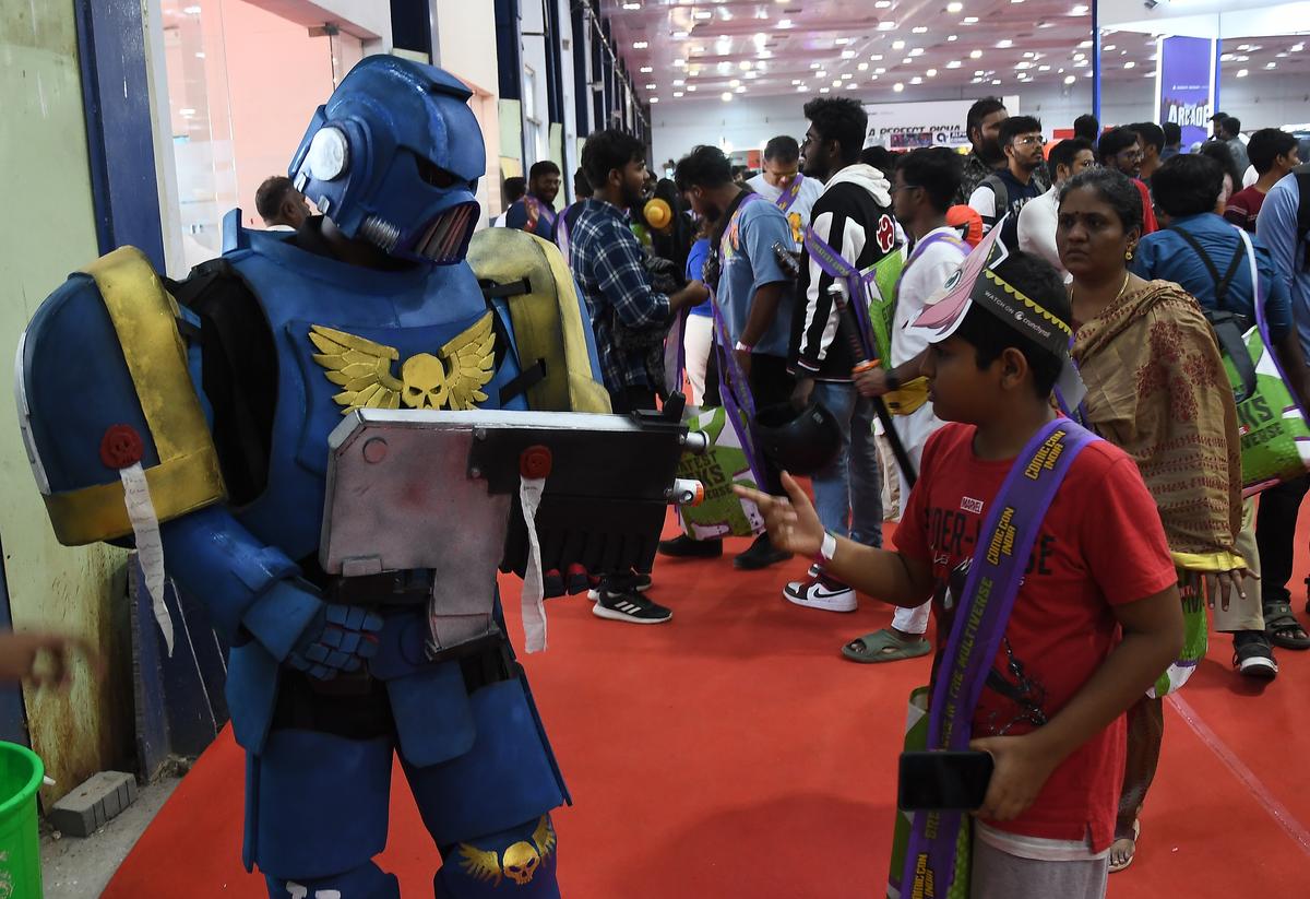  A boy interacts with a cosplayer at Comic Con in Chennai in 2024 