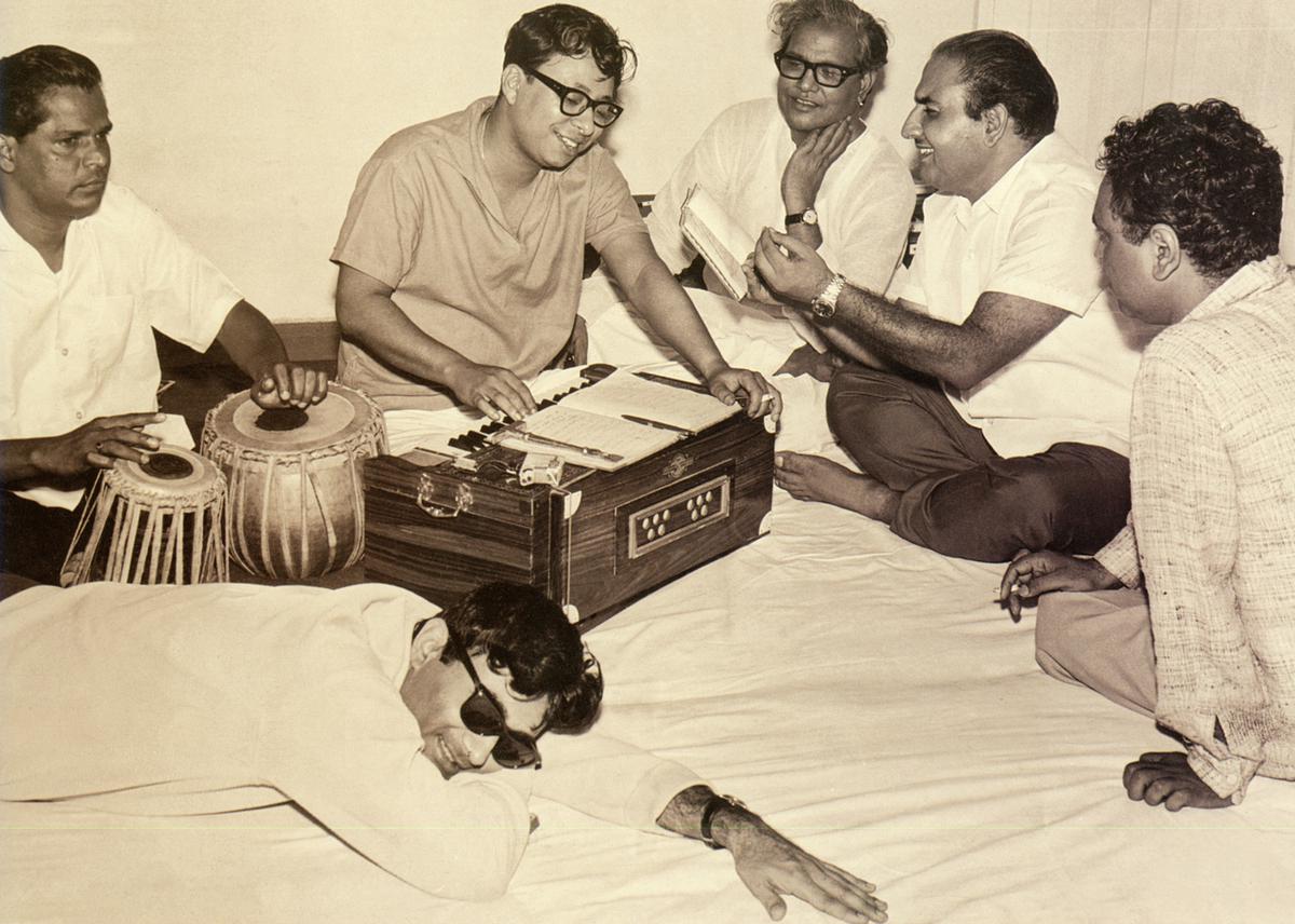 R. D. Burman with playback singer Mohammed Rafi, and actor Dev Anand during a rehearsal session.