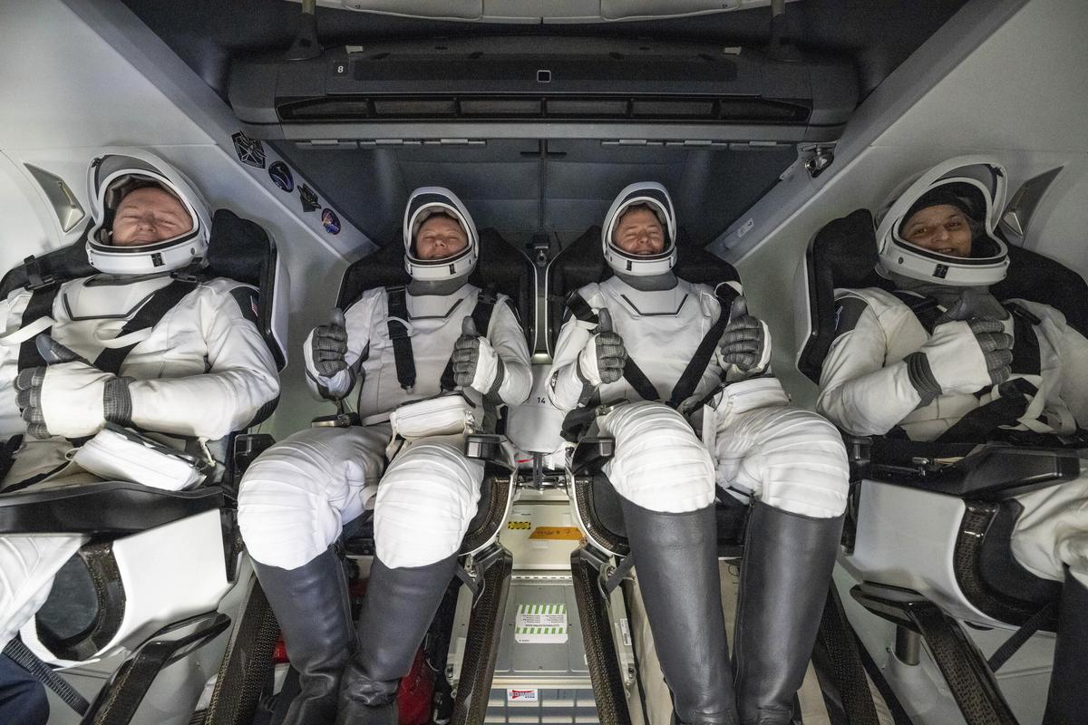 From left, NASA astronaut Butch Wilmore, Russia’s Alexander Gorbunov, and NASA astronauts Nick Hague and Suni Williams sit inside a SpaceX capsule onboard the SpaceX recovery ship Megan after landing in the water off the coast of Florida, on March 18, 2025. (Keegan Barber/NASA via AP)