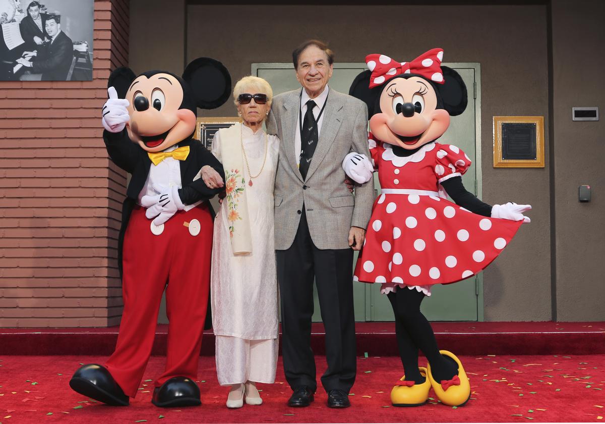 Mickey Mouse, from left, Elizabeth Gluck, Richard M. Sherman and Minnie Mouse pose for a photo at a ceremony honoring the Sherman Brothers by renaming Disney Studios Soundstage A at the world premiere 