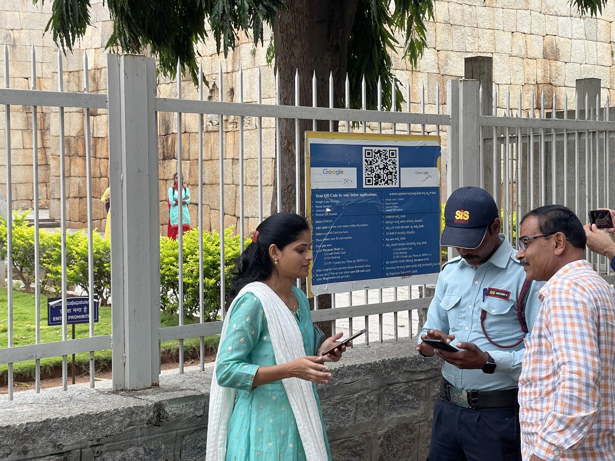 Tourists scan QR code to pay entrance fee at Chitradurga fort. 