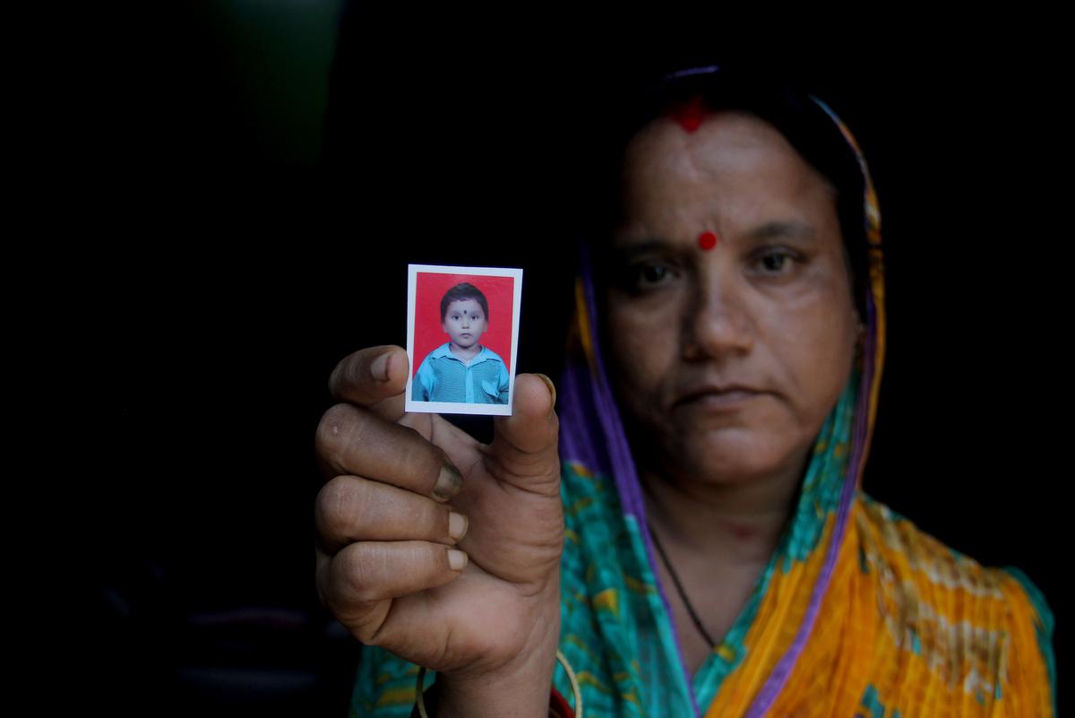 Puspalata Acharya shows a picture of her 10-year-old son Ashutosh, who died in a crocodile attack while taking a bath in the Brahmani river, flowing just 100 metres from their home in Nimapur, a coastal village in Odisha’s Kendrapara district.