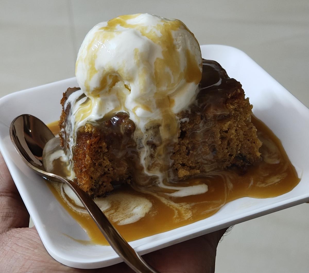 Sticky toffee pudding with vanilla ice cream from tree tree is at the top
