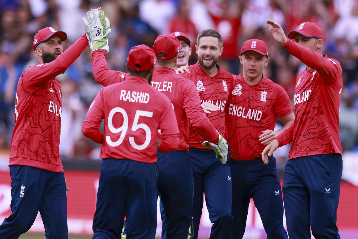 England’s Chris Woakes is congratulated by teammates after talking the wicket of India’s K. L. Rahul during the T20 World Cup cricket semifinal between England and India on November 10, 2022.