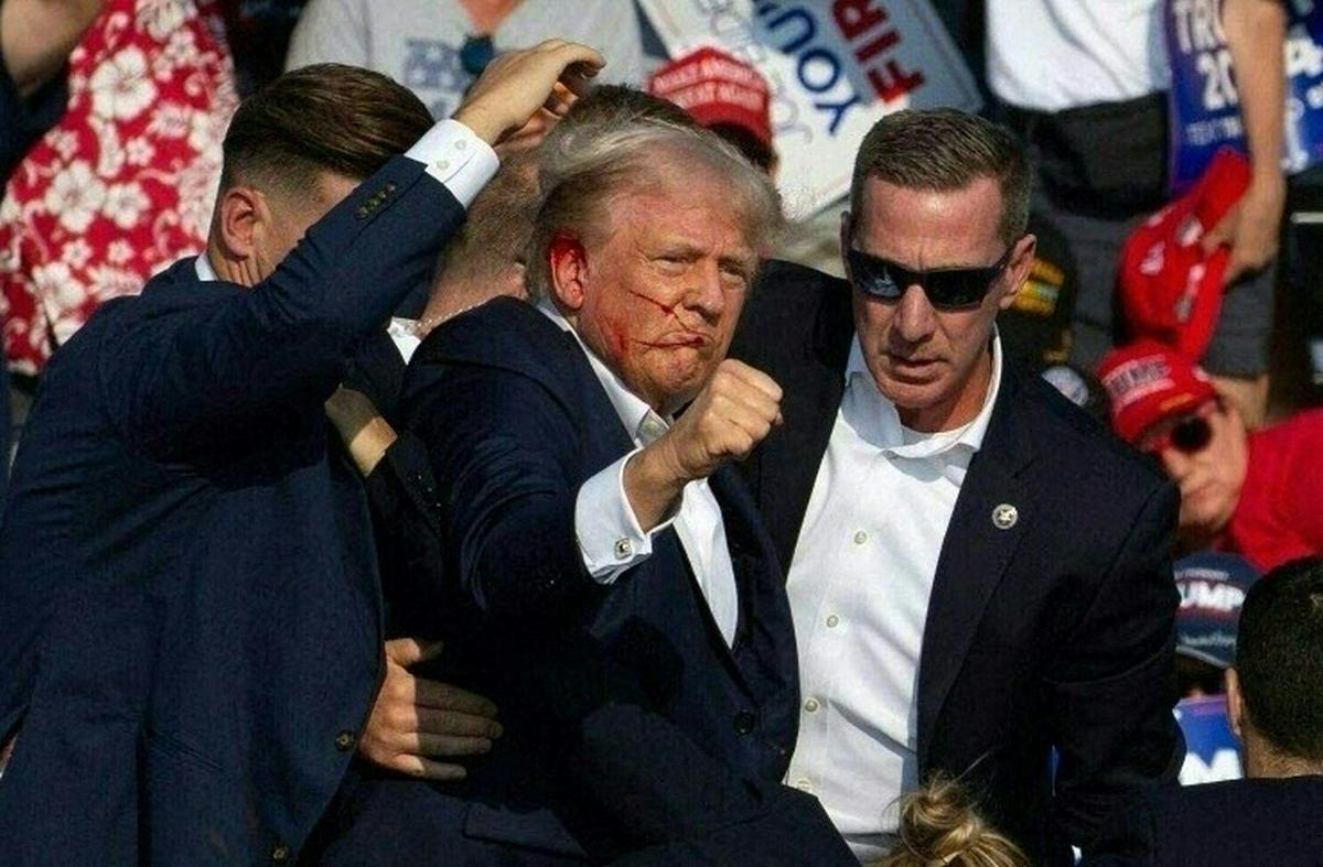 Republican candidate Donald Trump is seen with what appears to be blood on his face surrounded by secret service agents as he is taken off the stage at a campaign event at Butler Farm Show Inc. in Butler, Pennsylvania, on July 13, 2024. 