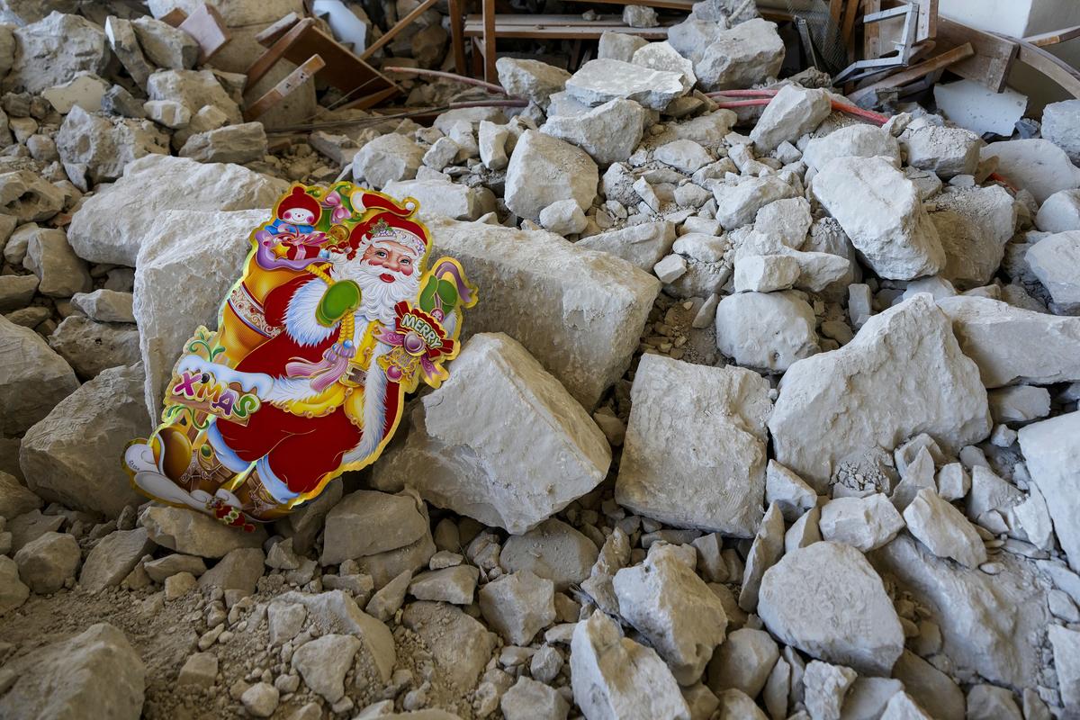 A Santa Claus Christmas decoration lies on the ground of St. George Melkite Catholic Church, that was destroyed by Israeli airstrike, in the town of Dardghaya in southern Lebanon, on December 22, 2024.