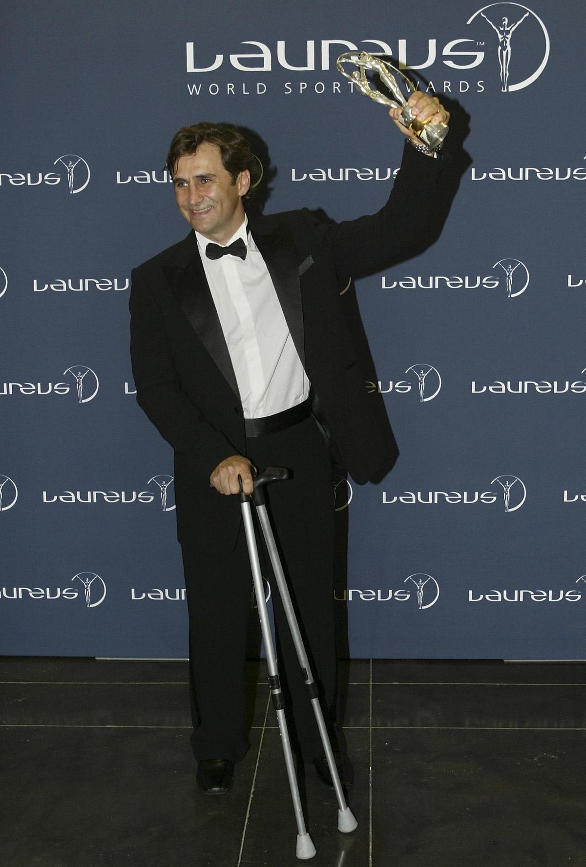 Alessandro Zanardi, from Italy, poses with his trophy after receiving the Laureus World Comeback Of The Year award, in 2005