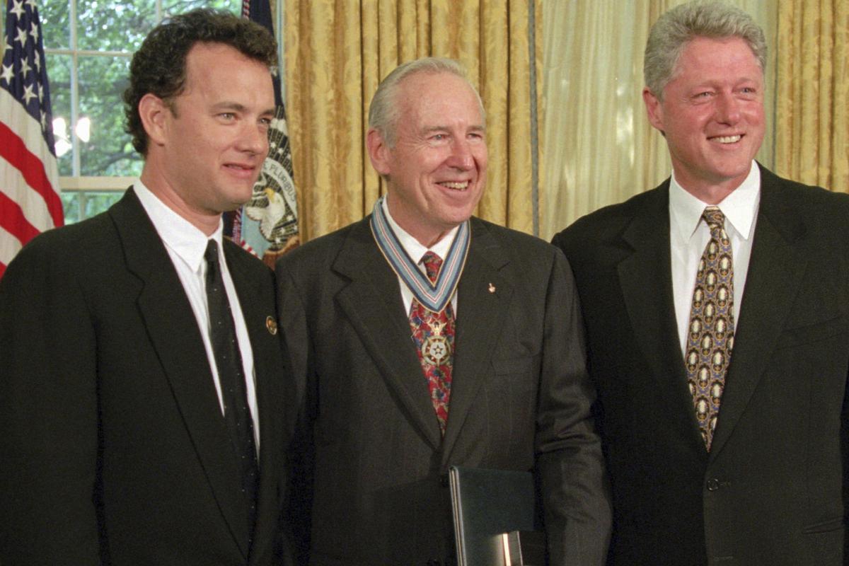 Former U.S. President Clinton stands with actor Tom Hanks, left, and former astronaut James Lovell in the Oval Office of the White House Wednesday, July 26, 1995, after presenting Lovell with the Congressional Space Medal of Honor. Hanks portrayed Lovell in the movie ‘Apollo 13’
