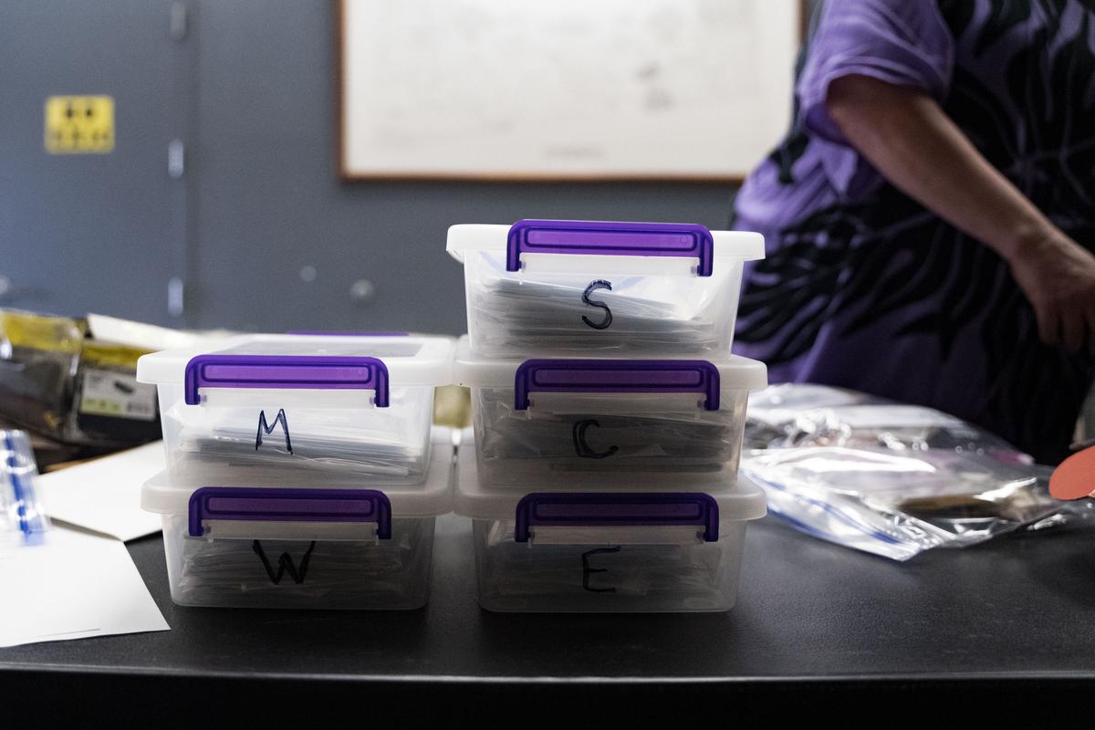 Containers of lists and photographs from each location of “Two by Twos” conventions organized by Pam Waltons are pictured at a library in Wailea, Hawaii. 