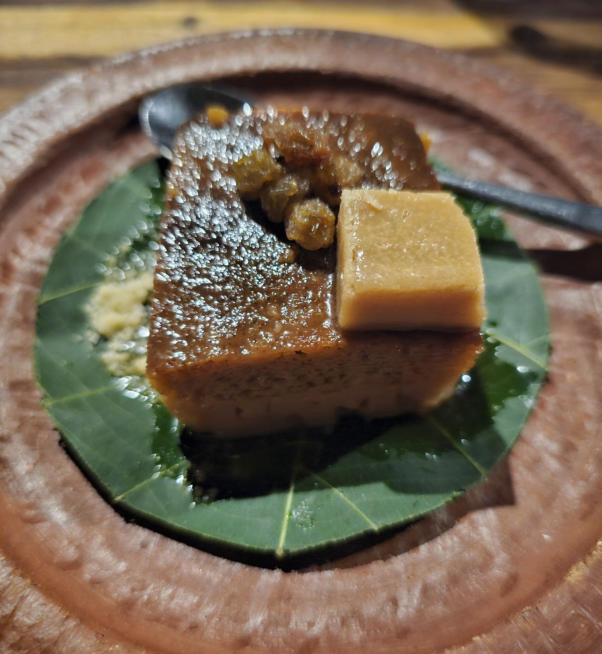 A creamy wattalapam topped with a cube of jaggery