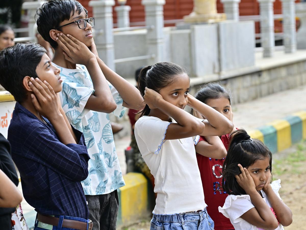 Children closing their ears when the air-raid siren went off during the civil defence drill in Bengaluru on Wednesday. 