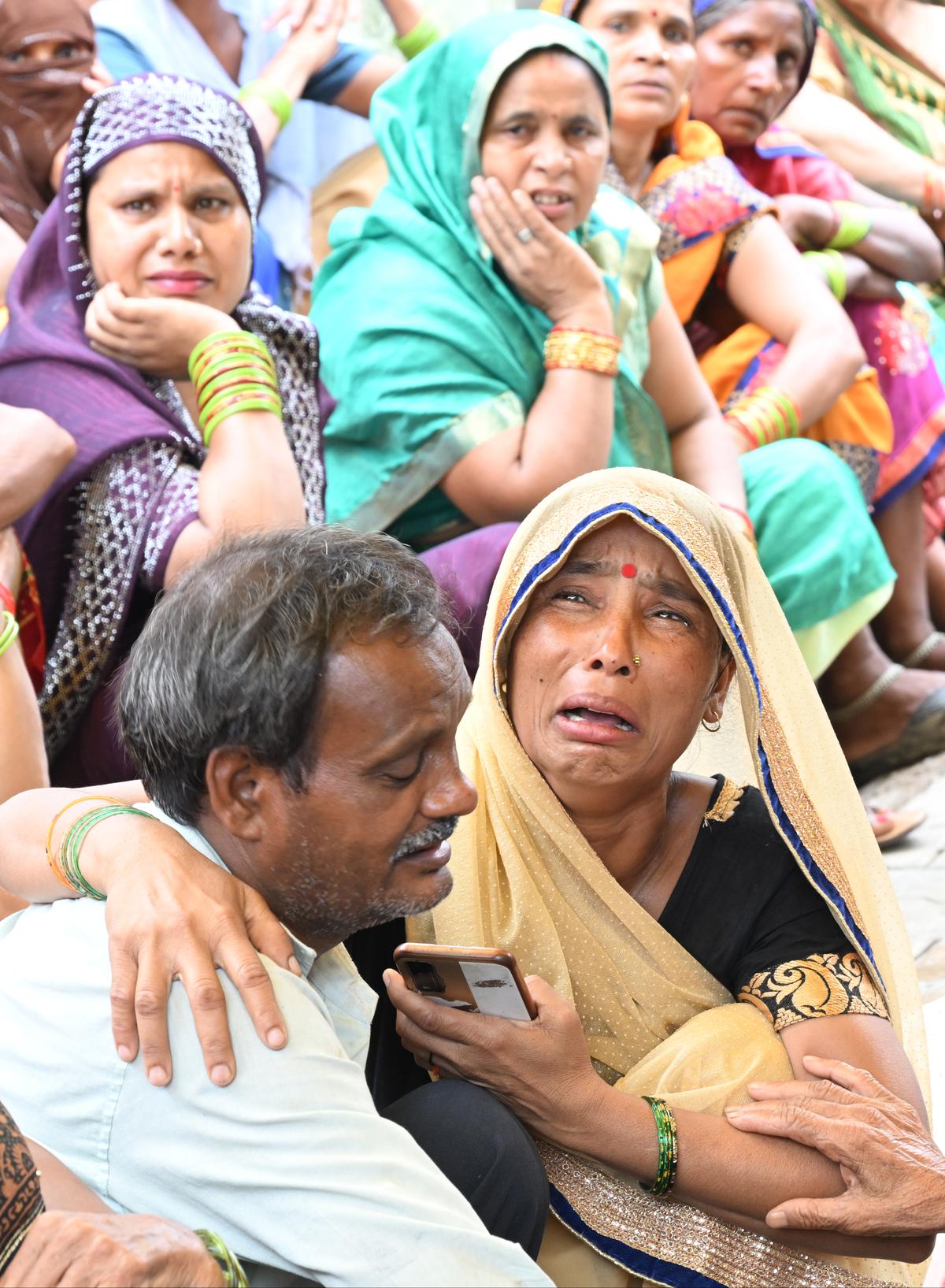 Vinod being consoled after the burial of his mother, wife and daughter after the stampede incident at Hathras in Uttar Pradesh on July 3, 2024. 