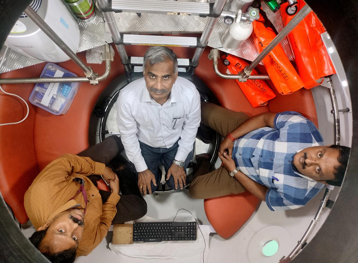 Three people sit inside a prototype of the Matsya6000 submersible made by the National Institute of Ocean Technology, Chennai.