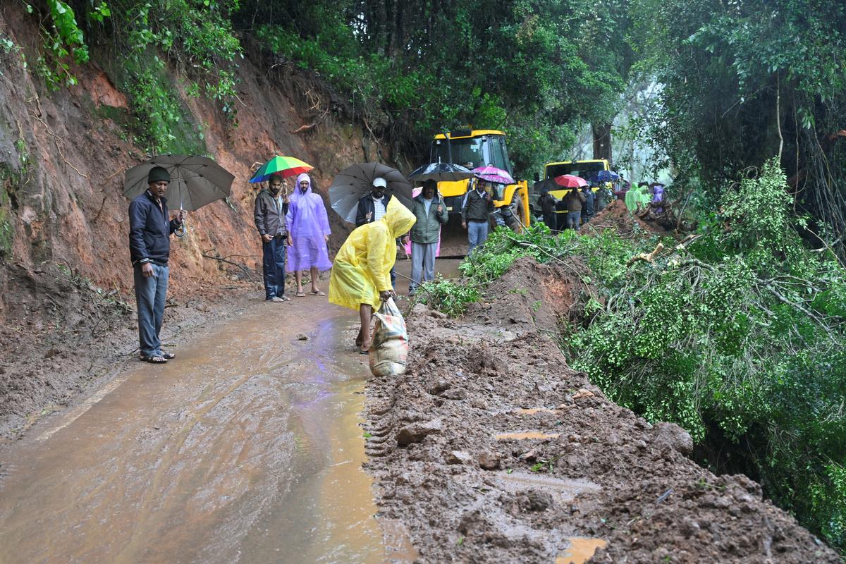 Highways Department men engaged in restoring the Ithalar-Bembatty road in the Nilgiris that was damaged due to heavy rain.