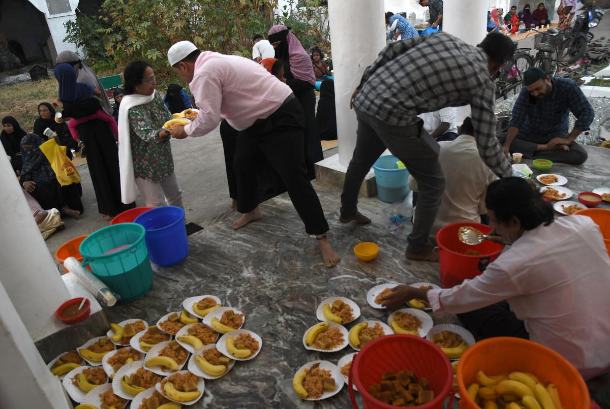 Volunteers of a temple in Chennai who serve food to their Muslim brothers during Ramzan at Big mosque in Triplicane on Saturday.