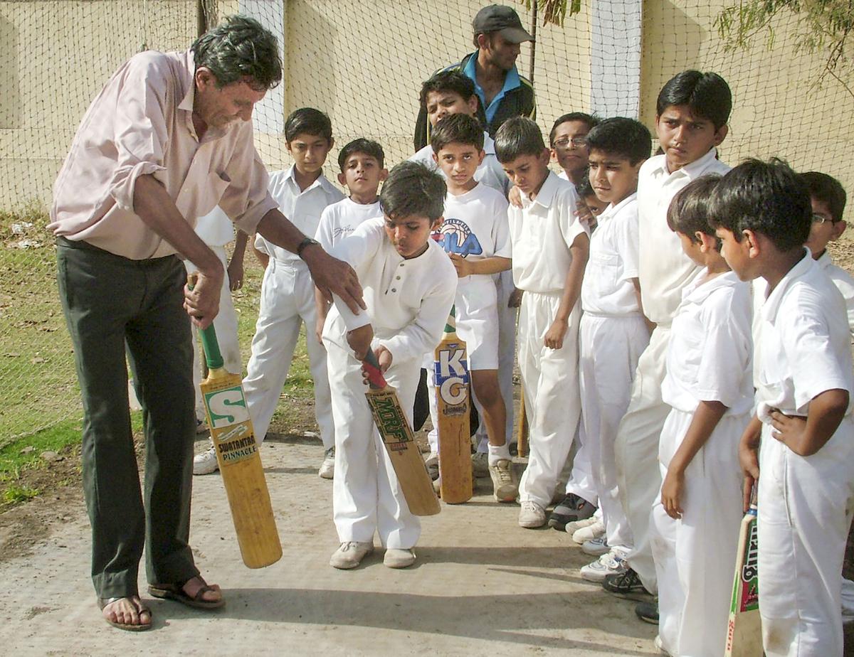 Salim Durani training budding cricketers in Jamnagar in January 2004.
