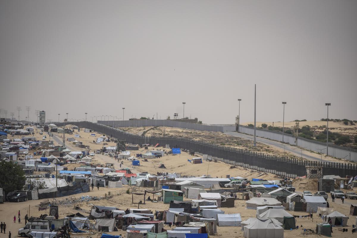 Palestinians displaced by the Israeli air and ground offensive on the Gaza Strip walk through a makeshift tent camp in Rafah, on the border with Egypt Gaza on May 10, 2024.