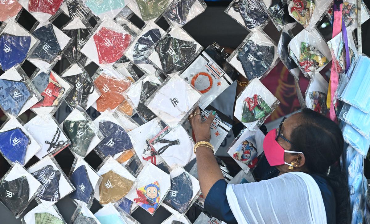 A street vendor arranging fresh stock of face masks displayed for sale in Thiruvananthapuram