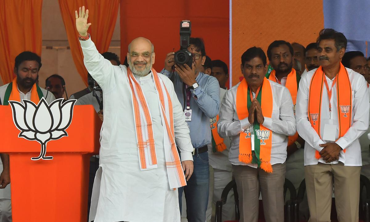 Union Home Minister Amit Shah waves at  supporters gathered at a meeting with booth level presidents, held at L.B. Stadium in Hyderabad on March 12, 2024. 