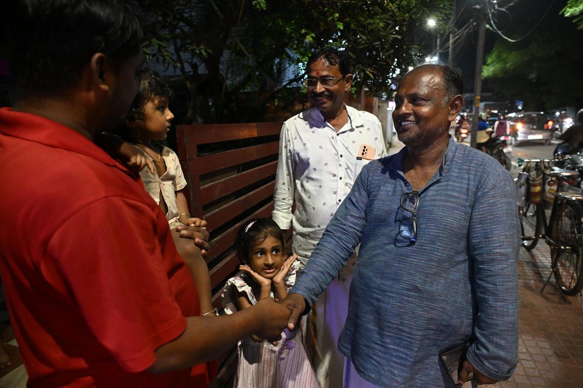 BJP candidate R. Sakhil interacting with voters at Petta.  