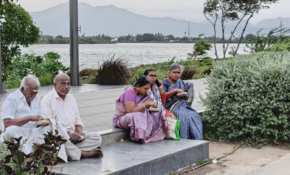 Families enjoy a picnic by the lake Families enjoy a picnic by the lake