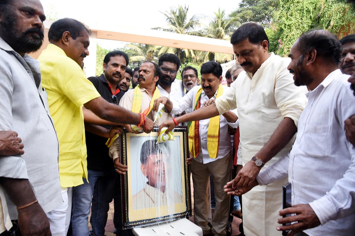 Former Minister Ganta Srinivasa Rao and other TDP leaders pouring milk on a portrait of former Chief Minister N. Chandrababu Naidu at the TDP office in Visakhapatnam on Tuesday.