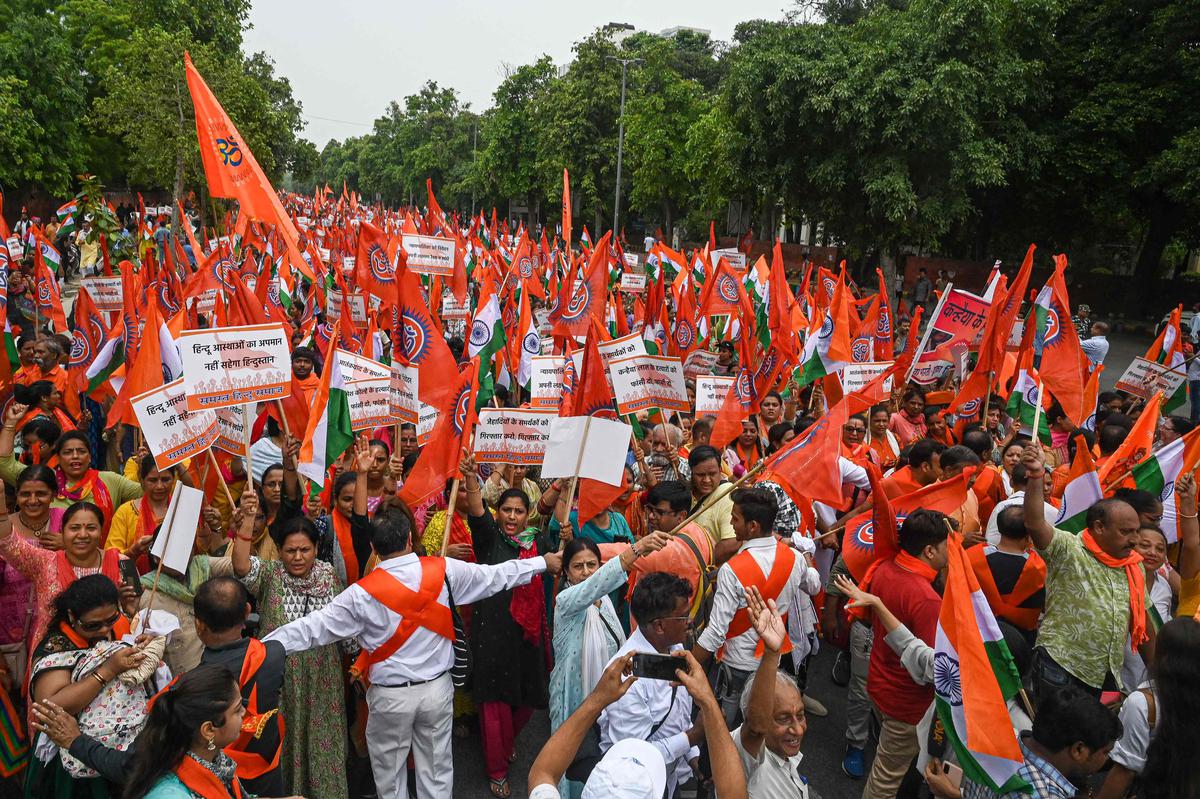 Supporters of Vishwa Hindu Parishad (VHP) and other Hindu organisations take part in the ‘Constitution Sankalp’, a resolution march to protest against the killing of a Hindu man in Udaipur city allegedly by two Muslim men, in New Delhi on July 9, 2022. 