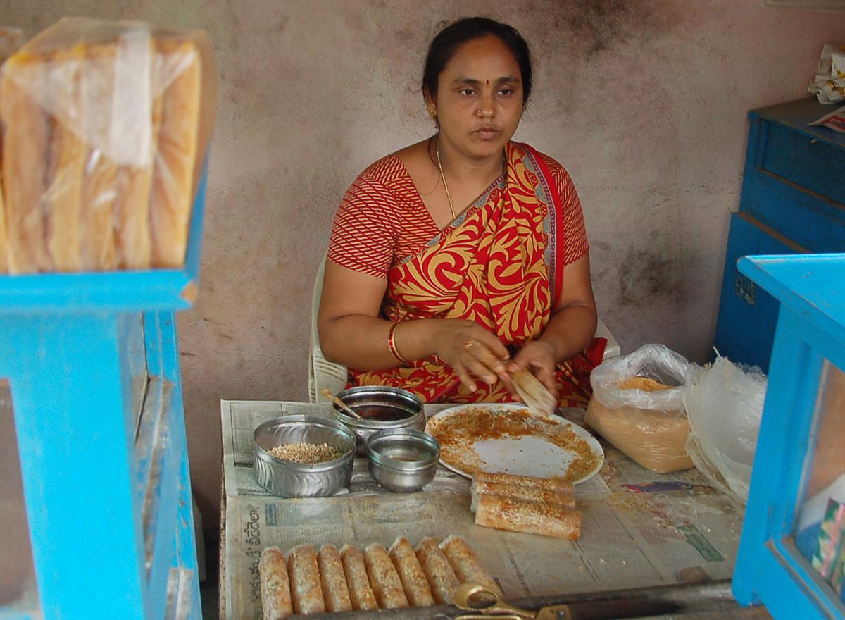 
A woman, Yatam Kanaka Durga, rolling Pootharekulu at Atreyapuram village in East Godavari district