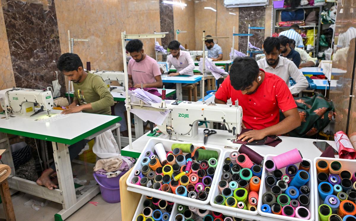 Tailors from West Bengal giving shape to blouses with precision and skill at Kiya Fashions boutique in Madurai. 