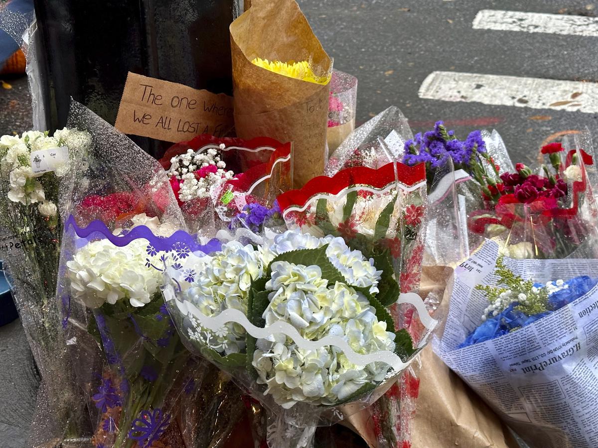 A makeshift memorial for Matthew Perry is seen outside the building known as the “Friends” building in New York, Sunday, Oct. 29, 2023. Fans lingered in the rain, taking pictures and leaving flowers on the corner outside the building shown in exterior shots on the popular TV show.