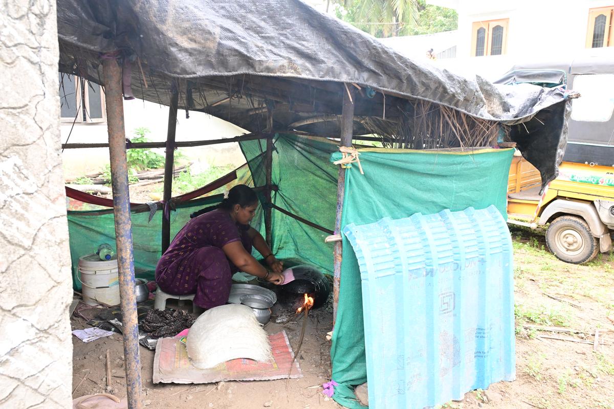A woman making rice paper at a small makeshift hut in Vasantawada village, Atreyapuram mandal, Dr. B.R. Ambedkar Konaseema district.