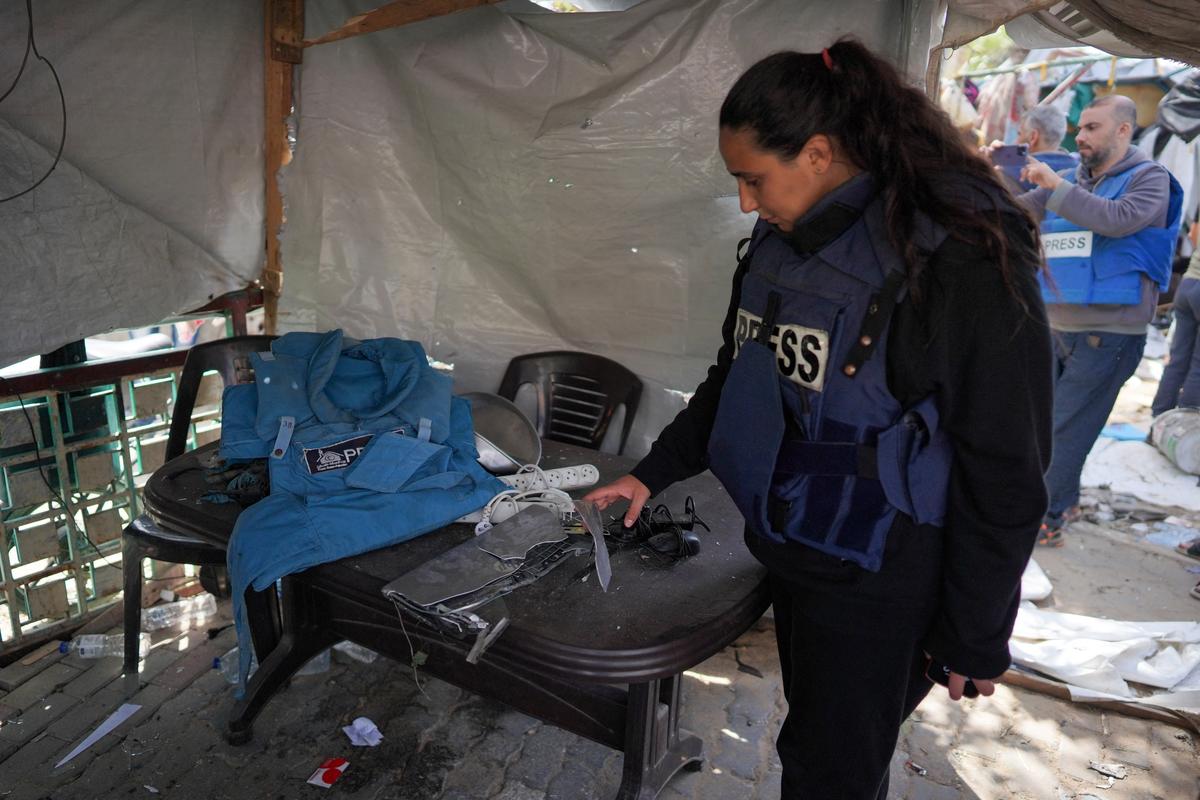 Palestinian journalist Hind Khoudary inspects a tent at a makeshift camp for displaced people in front of the Al-Aqsa Martyrs Hospital in Deir al-Balah in the central Gaza Strip, after it was hit by Israel bombardment on March 31, 2024, amid the ongoing battles Israel and the Hamas militant group. 