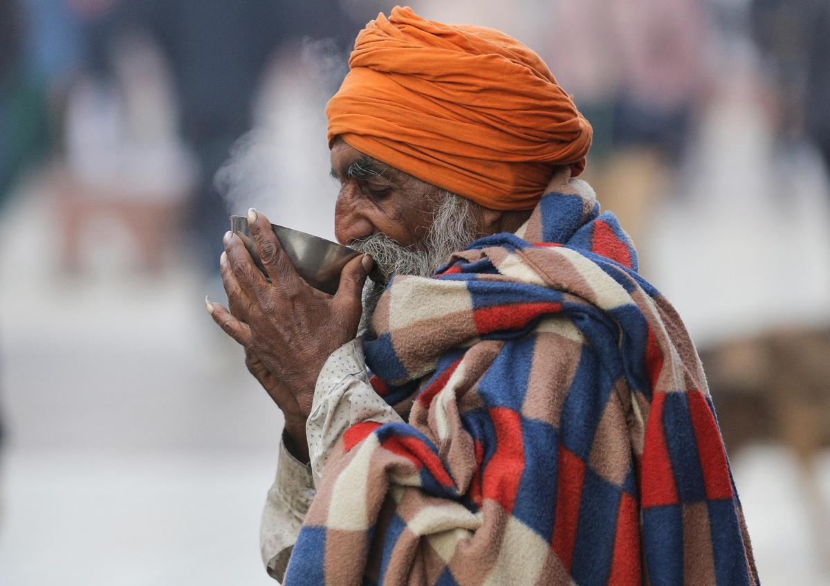  An elderly man wrapped in a blanket sips tea on a cold morning, at the Heritage Street, in Amritsar. File