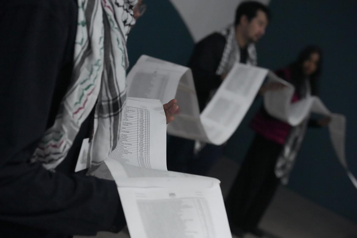 Activists participate in a demonstration where they say they are reading the names of victims of genocide at the COP29 U.N. Climate Summit in Baku, Azerbaijan on November 21, 2024.