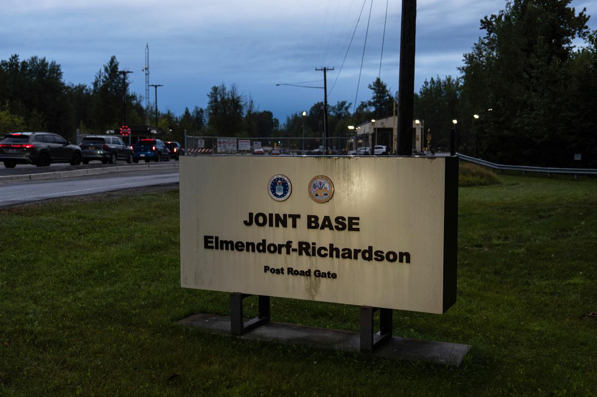 A line of vehicles waits to enter Joint Base Elmendorf-Richardson in Anchorage, Alaska on August 14, 2025, ahead of a meeting between President Donald Trump and Russian President Vladimir Putin. 