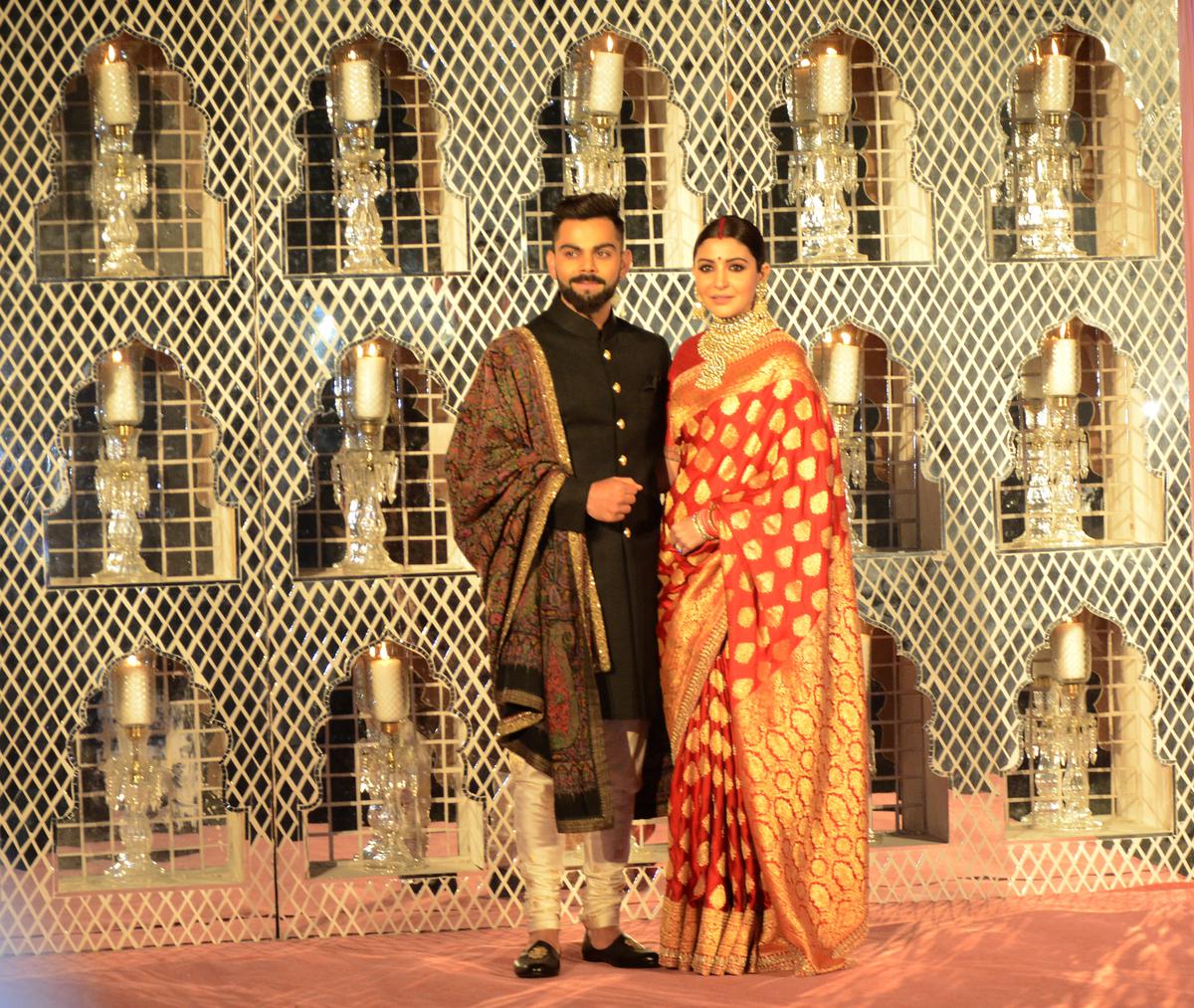 Virat Kohli and Anushka Sharma during their wedding reception in New Delhi. Anushka’s Banarasi sari drew attention and weavers received more orders, says master weaver Saeed Ur Rahman