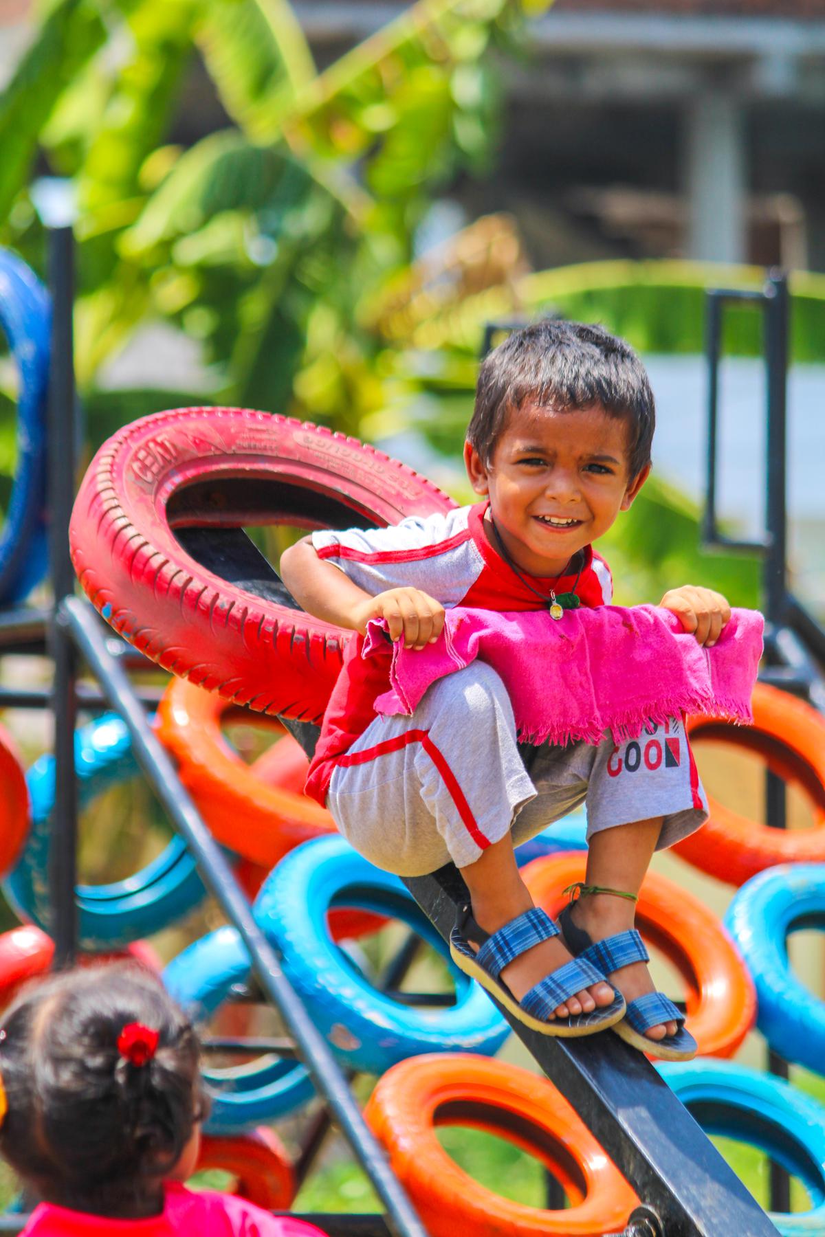 A child playing at a playground at an Anganwadi centre created with discarded tyres under Project Play, the brainchild of young IAS officer Dhatri Reddy, who is the Assistant Collector (UT) of Anakapalli district.