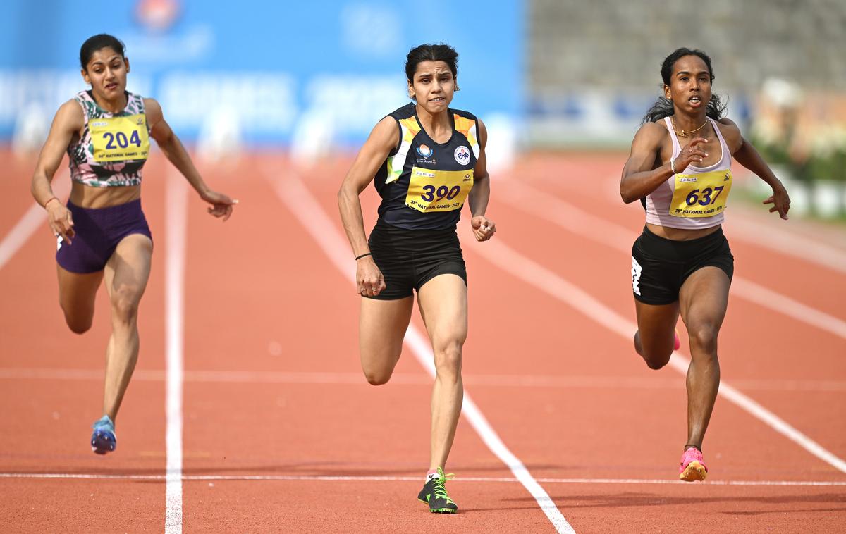 Sudeshna Shivankar, centre, of Maharashtra claims the women’s 100m gold at the 38th National Games in Dehradun on Saturday, 08 February 2025. 