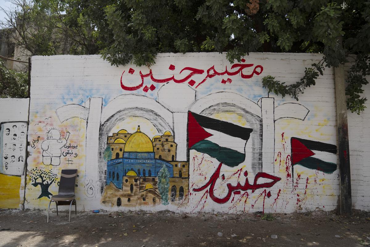 A mural that reads in Arabic “They will leave and we will stay, Jenin” in the occupied West Bank’s Jenin refugee camp, Jenin