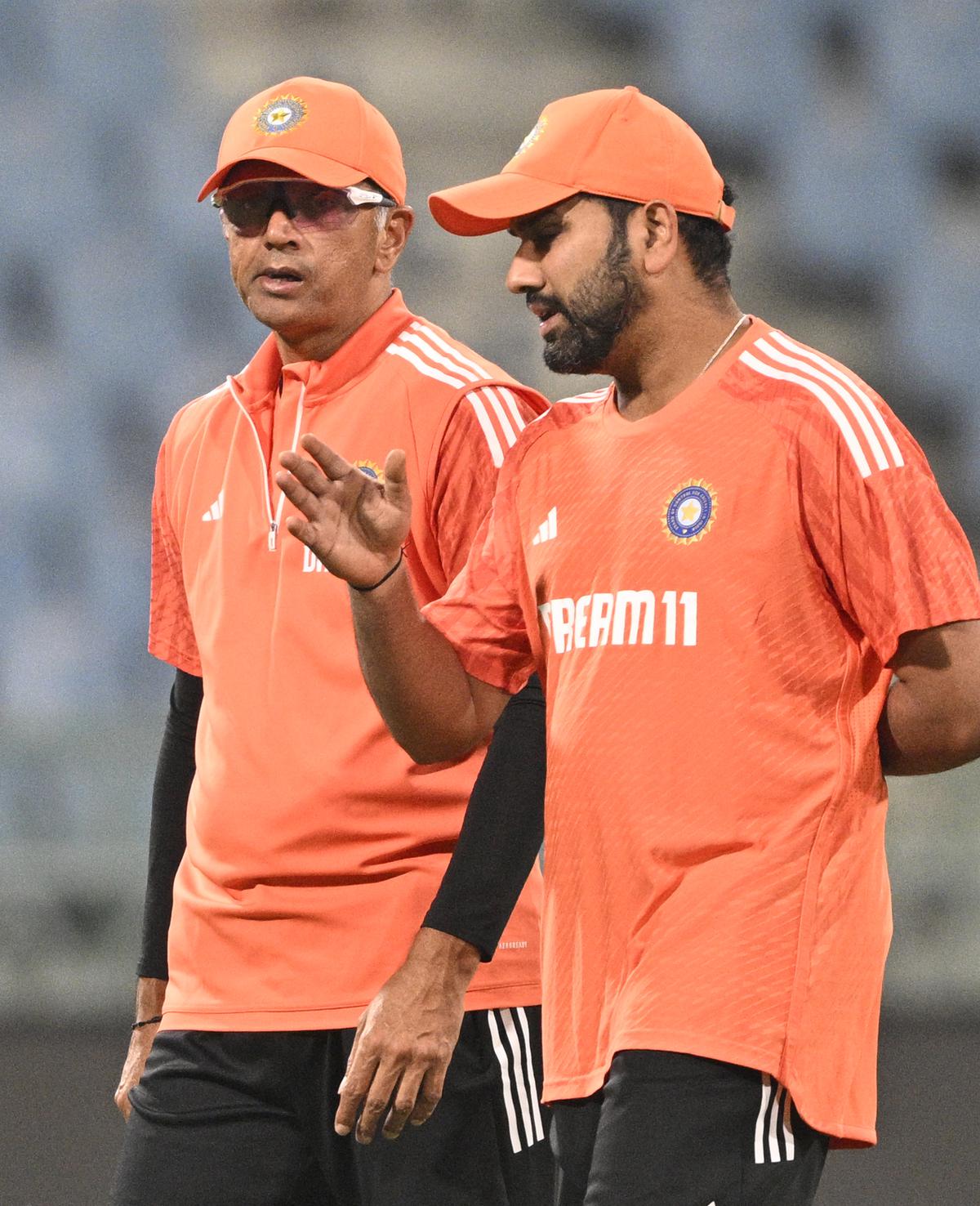 Talking tactics: Dravid and Rohit having a discussion ahead of the match.