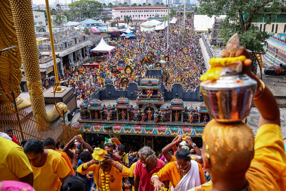 Hindu devotees carry milk pots and kavadis as they climb steps to Sri Subramaniar Swamy Temple during the Thaipusam festival at Batu Caves on February 05, 2023 in Selangor, Malaysia. 