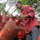 A worker unloads domestic LPG cylinders in Kochi on March 17, 2026