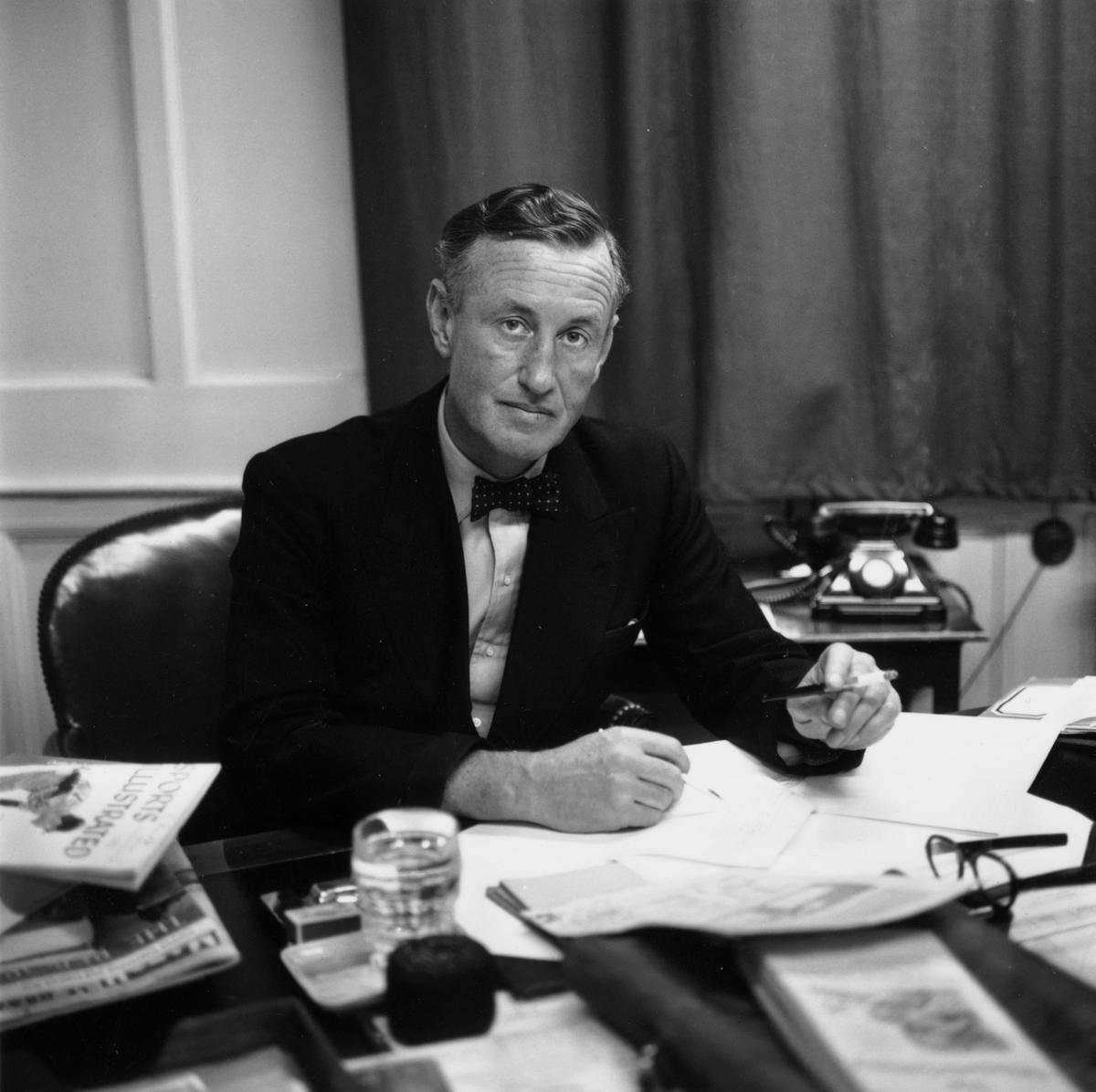 Ian Fleming, British author and creator of James Bond, at his desk in his study, in 1958.