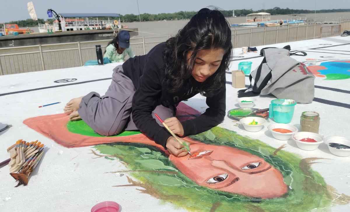 A girl engrossed in floor painting at Haritha Berm Park in Vijayawada on Sunday. A girl engrossed in floor painting at Haritha Berm Park in Vijayawada on Sunday.