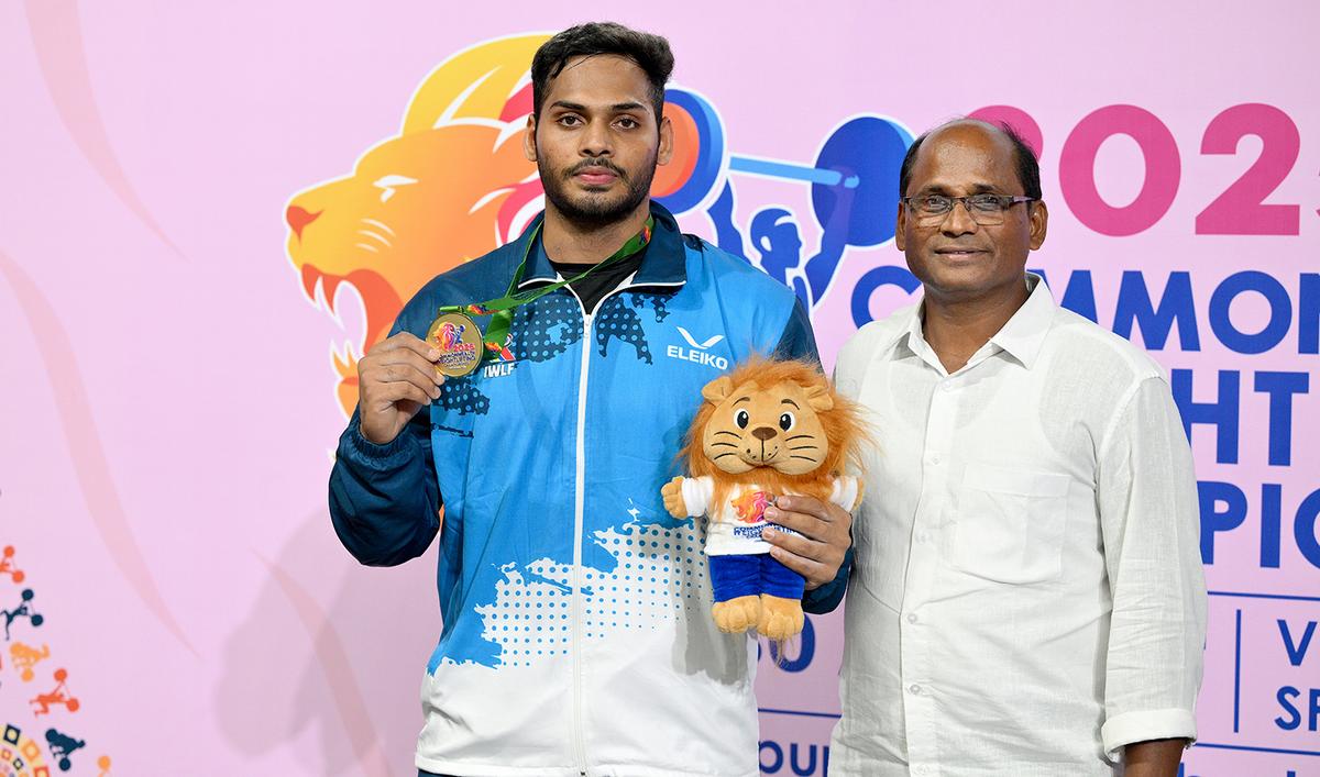 Ajaya Babu poses with his father Srinivasa Rao after winning the Commonwealth weightlifting championship gold in Ahmedabad. Ajaya Babu poses with his father Srinivasa Rao after winning the Commonwealth weightlifting championship gold in Ahmedabad.