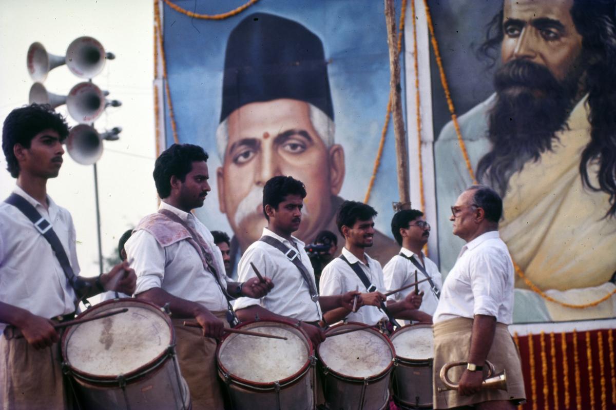 A Rashtriya Swayamsevak Sangh (RSS) band performs in front of portraits of its founder Keshav Baliram Hedgewar and M.S. Golwalkar at a rally in New Delhi. 