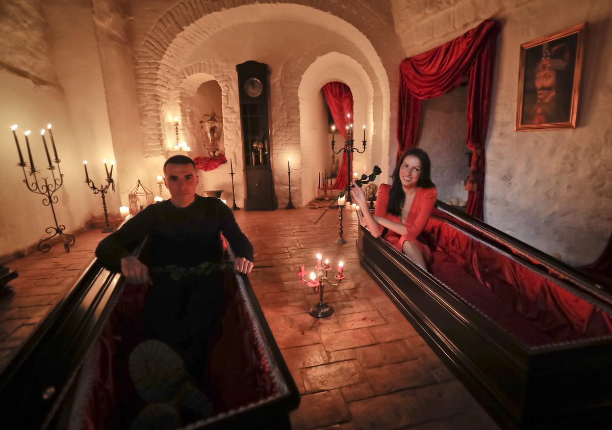 Tami Varma and her brother Robin, the grandchildren of Devendra Varma, a scholar of English gothic tales and an expert in vampire lore, pose in coffins at Bran Castle, in Bran, Romania, Monday, Oct. 31, 2016. PHOTO: Vadim Ghirda / AP