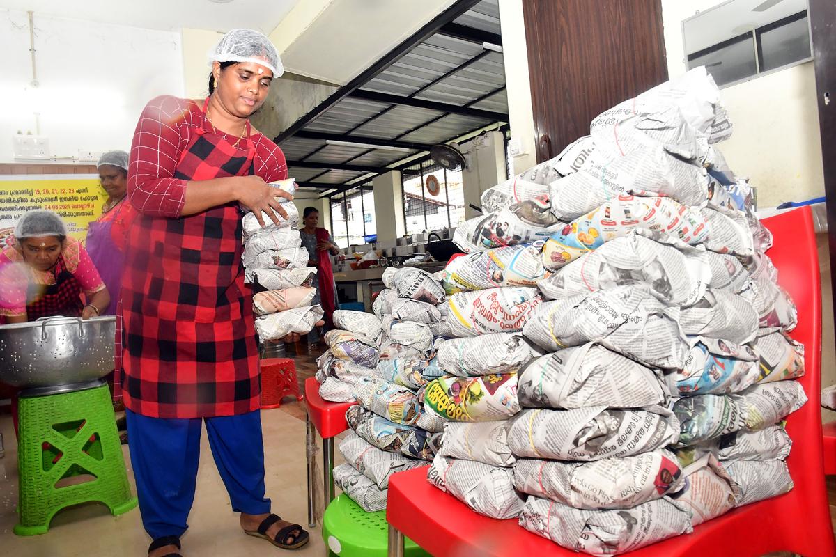 A women packing   meals at a Kudumbashree Janakeeya Hotel  in Thiruvananthapuram.