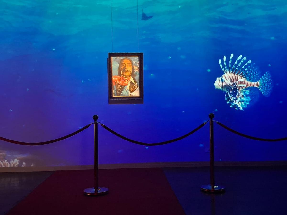 Animated sharks swimming around Nikas Safronov's painting of Salvador Dali.