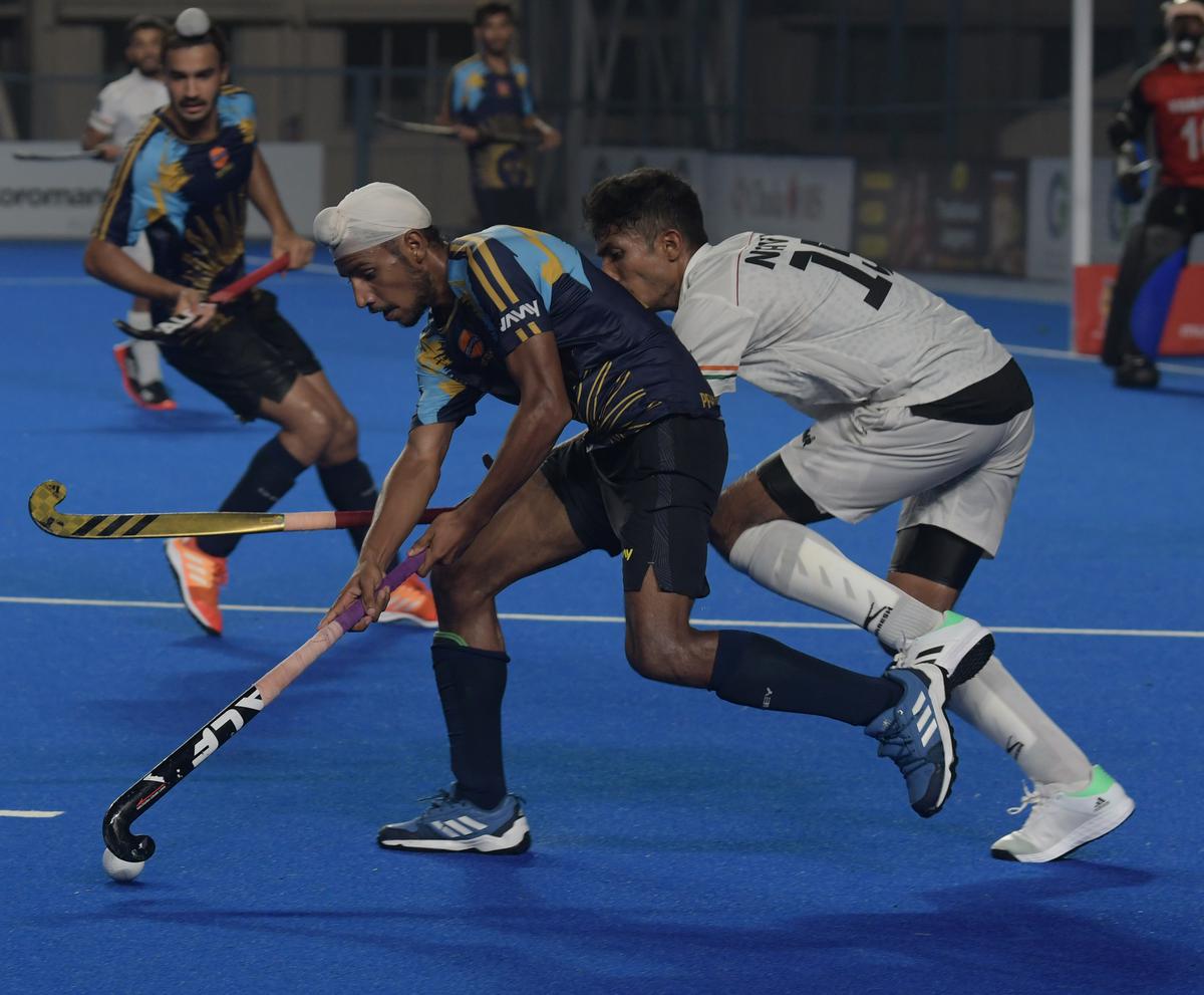 Arshdeep Singh, left, of IOC and K.T. Cariappa of Indian Navy in action during the 94th All India MCC Murugappa Gold Cup hockey at the Mayor Radhakrishnan Stadium in Chennai on Saturday, 26/08/2023.